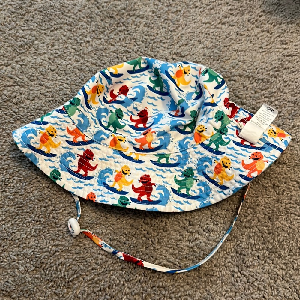 Surfing dinosaur sun hat